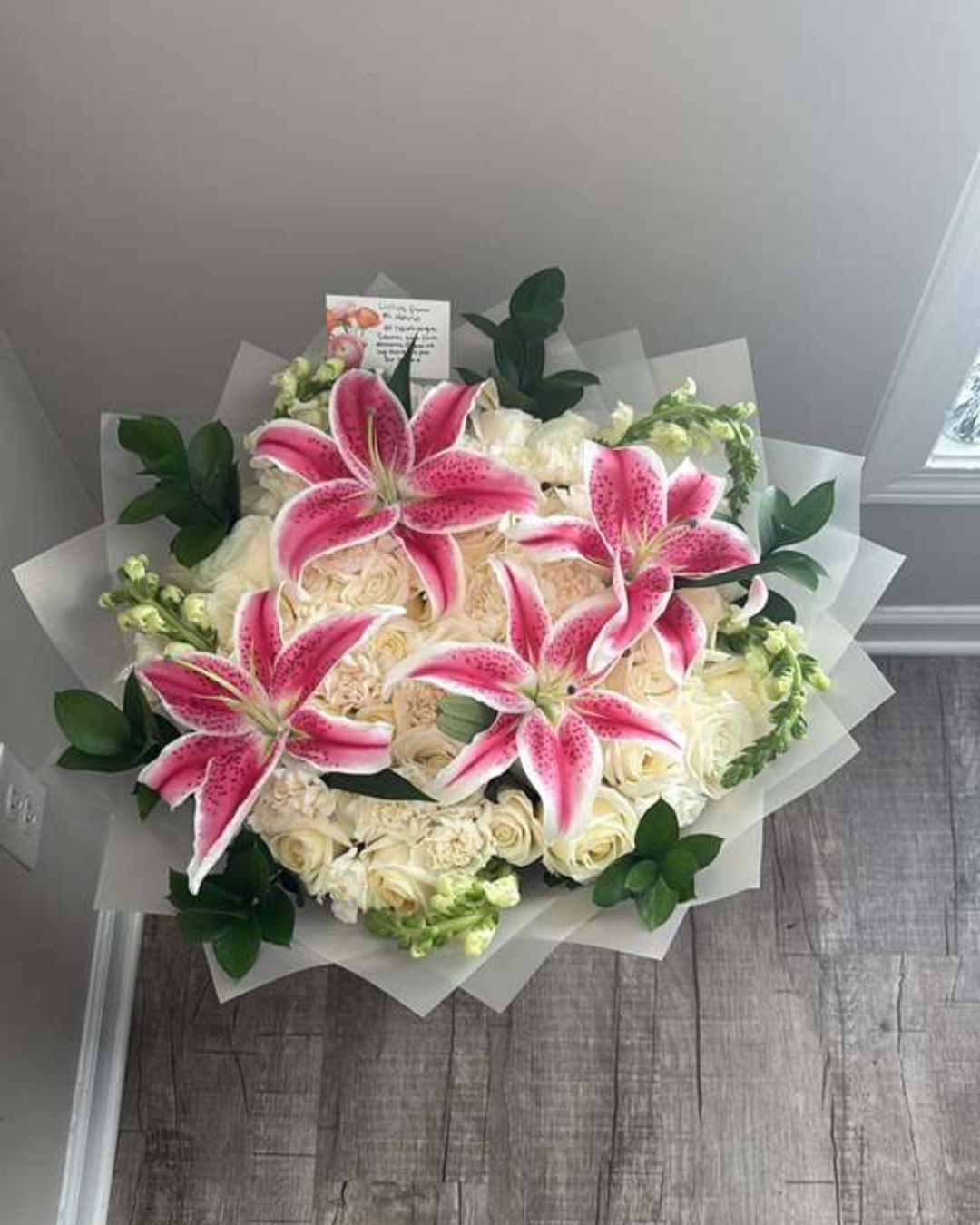 Princess floral arrangement with white roses, carnations, and snapdragons.