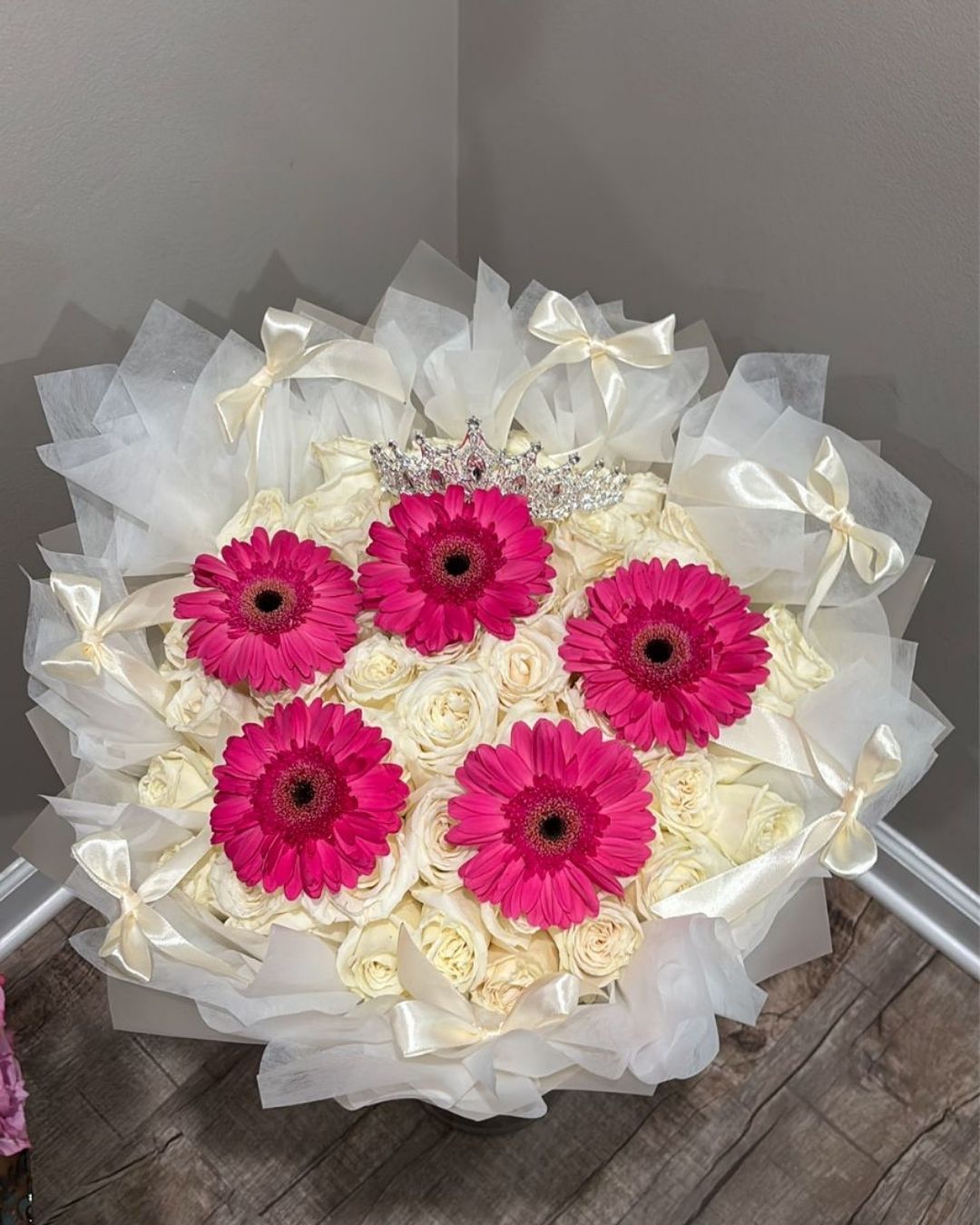 Tiffany floral arrangement with 50 white roses and fuchsia gerbera.