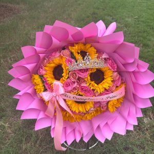 Remember Me Bouquet with 50 roses, nine sunflowers, a decorative crown, and a personalized ribbon