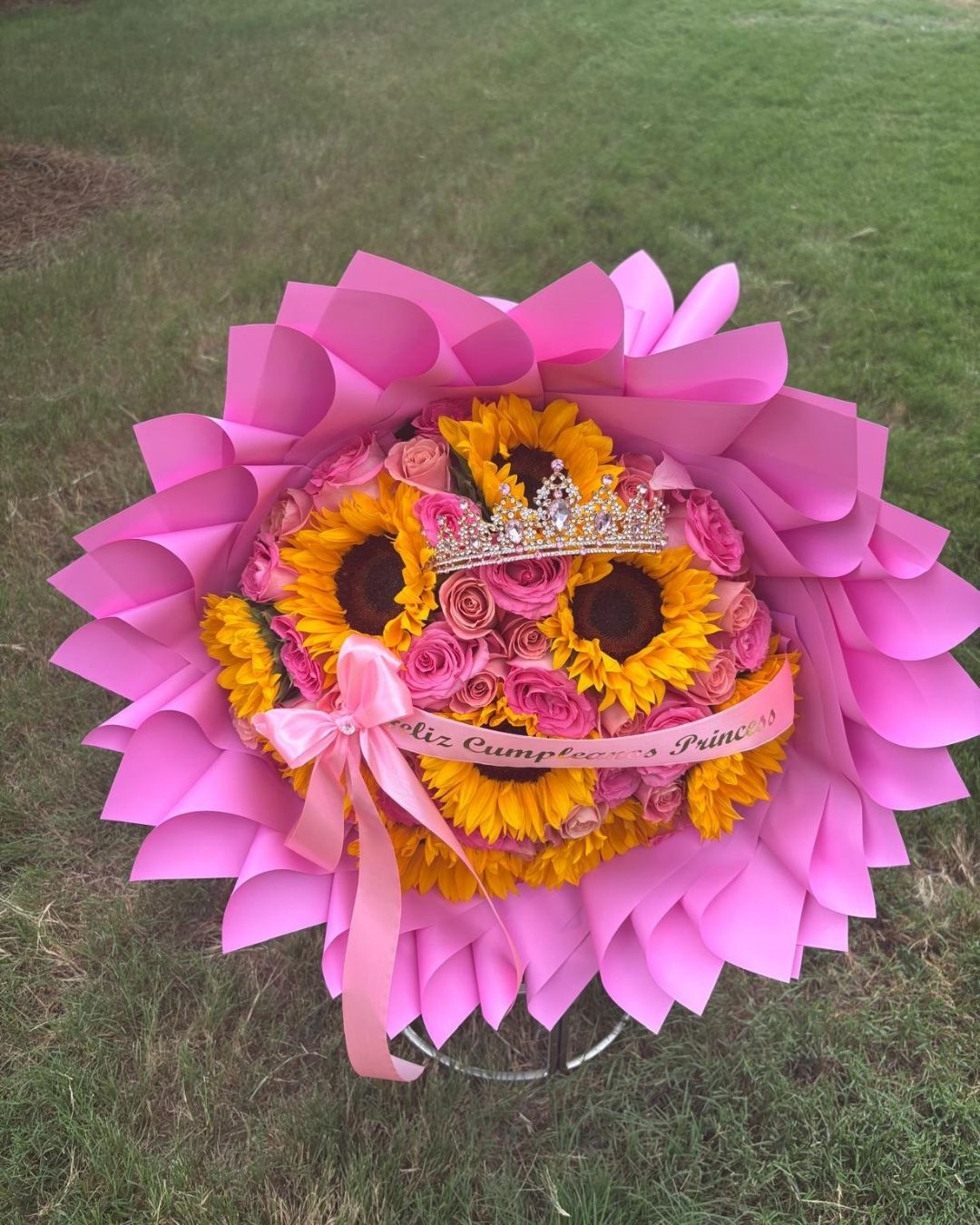 Remember Me Bouquet with 50 roses, nine sunflowers, a decorative crown, and a personalized ribbon
