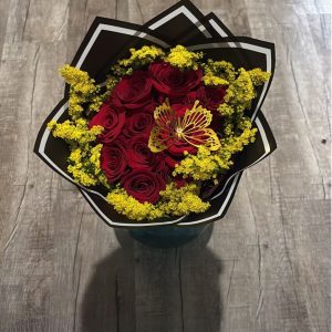 Solidago Bouquet of 12 red roses with yellow solidago, a gold butterfly decoration, and black wrapping with white trim.